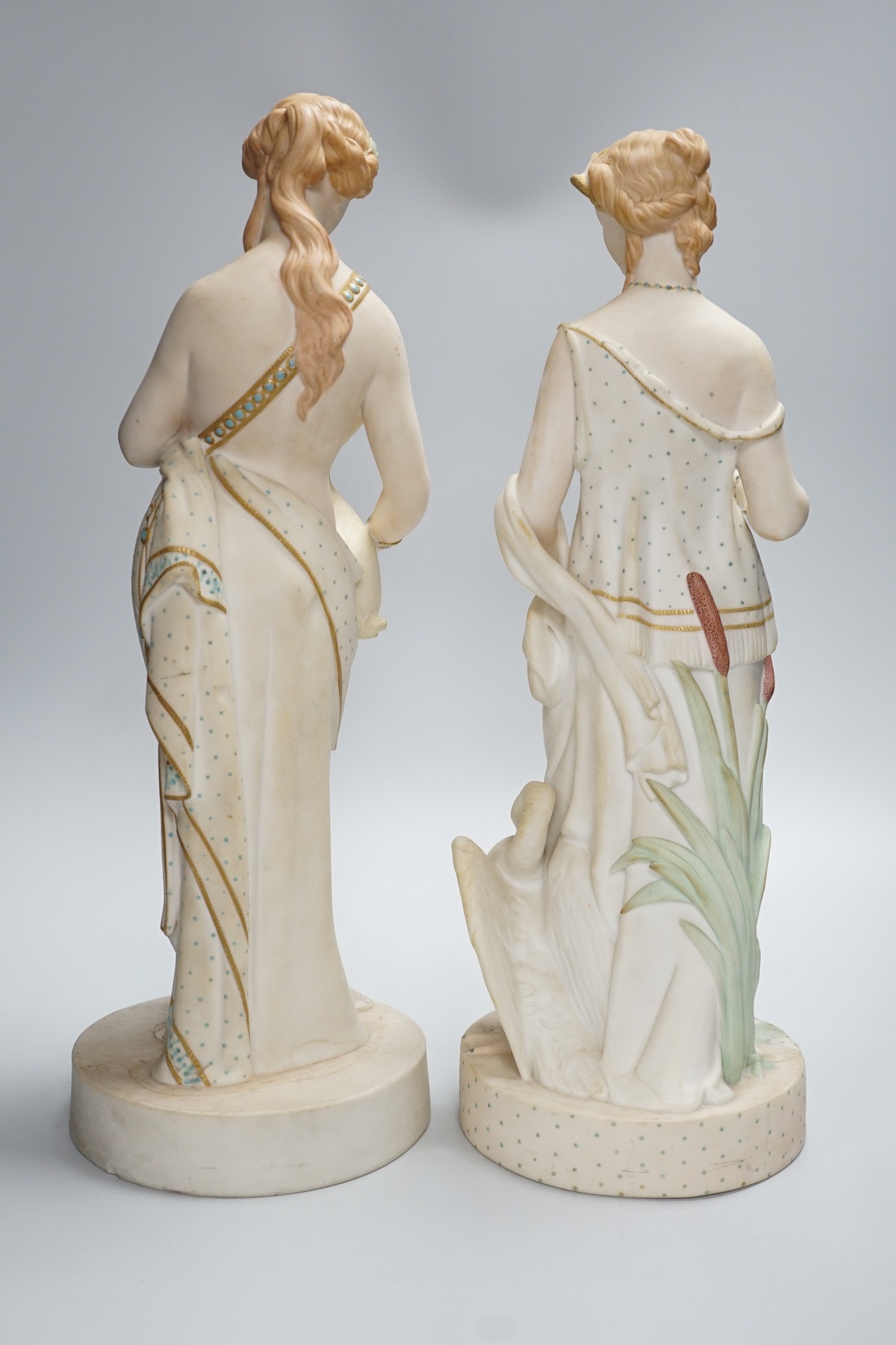 A pair of large W H Goss bisque classical female figures, one with lamb, the other Leda and the Swan, 45cm